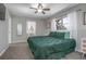Sunlit bedroom with carpet and a decorative bed complemented by a ceiling fan and bright white curtains at 2842 English Dr, Deltona, FL 32738