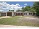 Charming single-story home with a brick and white exterior, a well-manicured lawn, and a driveway leading to an attached garage at 2842 English Dr, Deltona, FL 32738
