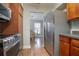 Well-lit kitchen featuring stainless steel appliances, wooden cabinets, and an adjacent dining area at 2842 English Dr, Deltona, FL 32738