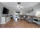 Cozy living room with hardwood floors, a comfortable sofa, a ceiling fan, and sliding glass door access to a screened-in porch at 2842 English Dr, Deltona, FL 32738