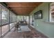 Enclosed sunroom with comfortable seating, a mounted TV, and a view of the outdoor surroundings at 2842 English Dr, Deltona, FL 32738