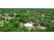 Aerial view of the home nestled among mature trees, showcasing the privacy and serene setting at 2953 Sled Rd, Christmas, FL 32709