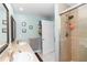 Well-lit bathroom featuring a double sink vanity, tiled shower with glass door and modern fixtures at 2953 Sled Rd, Christmas, FL 32709
