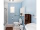 Bathroom featuring blue walls, shower, cabinet, and updated fixtures at 2953 Sled Rd, Christmas, FL 32709