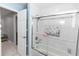 Bathroom with shower over tub and decorative tile at 2953 Sled Rd, Christmas, FL 32709