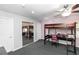Bright bedroom with a bunk bed featuring a study area, complemented by a mirrored closet and carpet flooring at 2953 Sled Rd, Christmas, FL 32709