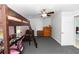 Bedroom featuring a bunk bed with a study area, complemented by a dresser and plush carpeting at 2953 Sled Rd, Christmas, FL 32709