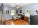 Cozy bedroom featuring hardwood floors, a ceiling fan, and natural light from the windows at 2953 Sled Rd, Christmas, FL 32709