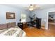 Comfortable bedroom with wood floors, natural light, and desk area at 2953 Sled Rd, Christmas, FL 32709