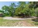 Circular driveway leads to the home, surrounded by mature trees at 2953 Sled Rd, Christmas, FL 32709