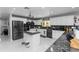 Modern kitchen with an island, stainless steel appliances, white cabinets, and dark countertops at 2953 Sled Rd, Christmas, FL 32709