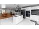 Bright, open kitchen featuring an island, stainless steel appliances, white cabinets, and a view to the dining room at 2953 Sled Rd, Christmas, FL 32709