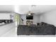 Spacious living room with a large gray sectional sofa, ceiling fan, and sliding glass doors to the outside at 2953 Sled Rd, Christmas, FL 32709