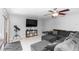 Cozy living room featuring a dark gray sectional, TV, and a telescope for stargazing at 2953 Sled Rd, Christmas, FL 32709