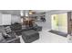 Comfortable living room featuring a large gray sectional sofa, sliding glass doors, and bright tile flooring at 2953 Sled Rd, Christmas, FL 32709