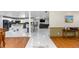 Open concept living space with white tile floors, modern kitchen, and comfortable seating area at 2953 Sled Rd, Christmas, FL 32709