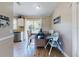 Cozy dining area with wood floors, large window, and space for a high chair at 2978 Greynolds St, Deltona, FL 32738