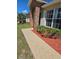 Charming home featuring brick accents, a walkway, and manicured landscaping at 2978 Greynolds St, Deltona, FL 32738