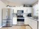 Modern kitchen featuring stainless steel appliances, granite counters, and ample storage, perfect for cooking at 2978 Greynolds St, Deltona, FL 32738