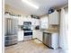 Modern kitchen with stainless steel appliances, white cabinets, granite countertops, and hardwood flooring at 2978 Greynolds St, Deltona, FL 32738