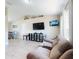 Spacious living room with comfortable seating and a media center, great for entertaining and relaxing at 2978 Greynolds St, Deltona, FL 32738