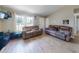 Bright living room with lots of natural light features updated flooring and comfortable seating for relaxation at 2978 Greynolds St, Deltona, FL 32738