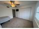 Comfortable bedroom with a large closet, ceiling fan and a sunlit window at 3003 S Atlantic Ave # 17A1, Daytona Beach Shores, FL 32118