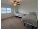 Bright bedroom featuring two beds, a ceiling fan, and natural light at 3003 S Atlantic Ave # 17A1, Daytona Beach Shores, FL 32118