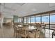 Spacious dining area with large windows, multiple tables, and plenty of natural light at 3003 S Atlantic Ave # 17A1, Daytona Beach Shores, FL 32118