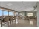 Spacious dining area with large windows, multiple tables, and plenty of natural light at 3003 S Atlantic Ave # 17A1, Daytona Beach Shores, FL 32118