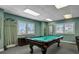 Inviting game room features a billiards table, comfortable seating, and ample natural light at 3003 S Atlantic Ave # 17A1, Daytona Beach Shores, FL 32118