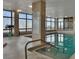 Well-lit indoor pool area with clear water, surrounded by large windows, and tiled surfaces at 3003 S Atlantic Ave # 17A1, Daytona Beach Shores, FL 32118