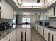Long, well-lit kitchen with island and adjacent desk area at 3003 S Atlantic Ave # 17A1, Daytona Beach Shores, FL 32118