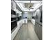 Kitchen with stainless steel appliances, light wood floors, and ceiling fan at 3003 S Atlantic Ave # 17A1, Daytona Beach Shores, FL 32118