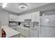 Bright kitchen with white cabinetry, modern appliances, and quartz countertops at 3003 S Atlantic Ave # 17A1, Daytona Beach Shores, FL 32118