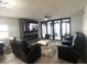 Relaxing living room featuring recliners, a sleek fireplace, and a scenic view at 3003 S Atlantic Ave # 17A1, Daytona Beach Shores, FL 32118
