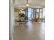 Inviting lobby area featuring a round table with floral arrangement, comfortable seating, and large windows at 3003 S Atlantic Ave # 17A1, Daytona Beach Shores, FL 32118