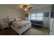 Comfortable bedroom with bed, sofa, a ceiling fan, and natural light from the windows at 3003 S Atlantic Ave # 17A1, Daytona Beach Shores, FL 32118