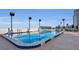 Beautiful rooftop pool with clear blue water, lounge chairs, and ocean views at 3003 S Atlantic Ave # 17A1, Daytona Beach Shores, FL 32118