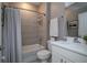 This bathroom has tiled walls, a vanity with storage, tub and shower combination, and a framed mirror at 3026 Adrian Dr, Ormond Beach, FL 32174