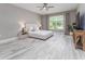 Serene bedroom with neutral tones, tile floors, a large window, and ample natural light at 3026 Adrian Dr, Ormond Beach, FL 32174