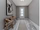 Inviting foyer with neutral walls, stylish wood-look flooring, a decorative table, and an art piece at 3026 Adrian Dr, Ormond Beach, FL 32174