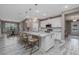 Open concept kitchen with a large island, pendant lights, and a view of the dining area and living room at 3026 Adrian Dr, Ormond Beach, FL 32174