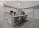 Modern kitchen with an island, white cabinetry, granite countertops, stainless steel appliances, and bar stool seating at 3026 Adrian Dr, Ormond Beach, FL 32174