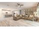 Inviting living room with tile floors, a leather couch, and a view of the modern kitchen and island at 3026 Adrian Dr, Ormond Beach, FL 32174