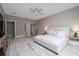Light-filled main bedroom with wood-look tile floors, neutral walls, and a view of the bathroom at 3026 Adrian Dr, Ormond Beach, FL 32174