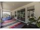 Relax on this covered patio with outdoor furniture and stylish rug with views of the backyard and landscaping at 3026 Adrian Dr, Ormond Beach, FL 32174