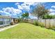 Spacious backyard featuring a well-maintained lawn, lush landscaping, and a sturdy wooden fence at 31 River Shore Dr, Ormond Beach, FL 32176