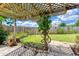 Charming backyard patio with lattice pergola providing shade and a cozy outdoor space at 31 River Shore Dr, Ormond Beach, FL 32176