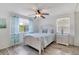 Bright bedroom with wood-look floors, a ceiling fan, and charming beach-themed decor at 31 River Shore Dr, Ormond Beach, FL 32176